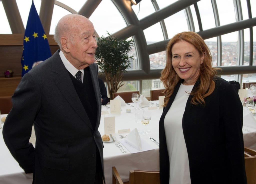 Giscard d'Estaing posing for a picture with a woman