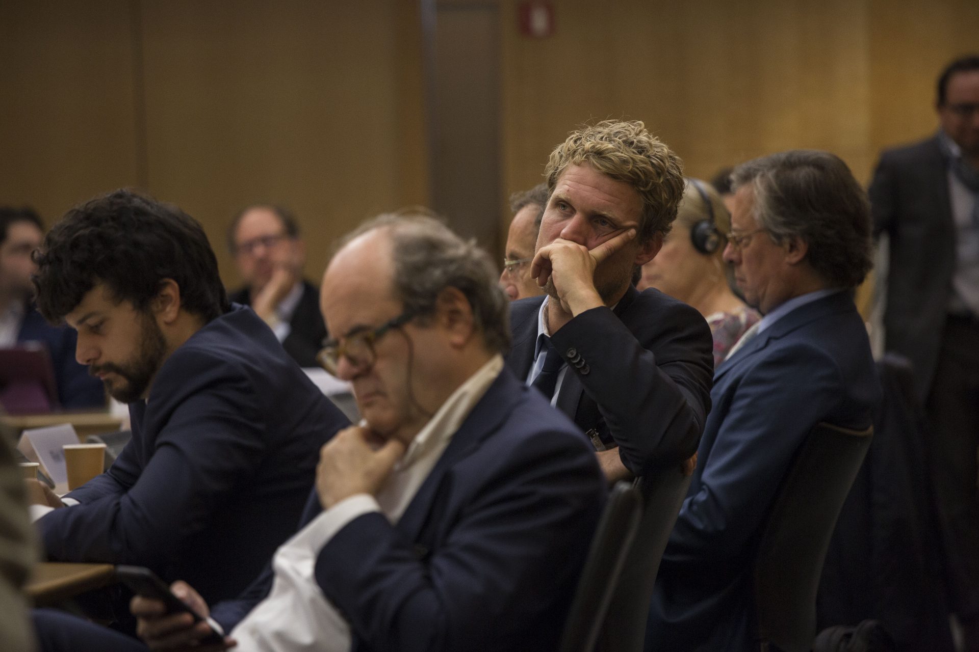Man listening in the First annual meeting of Re-Imagine Europa at the OECD in Paris