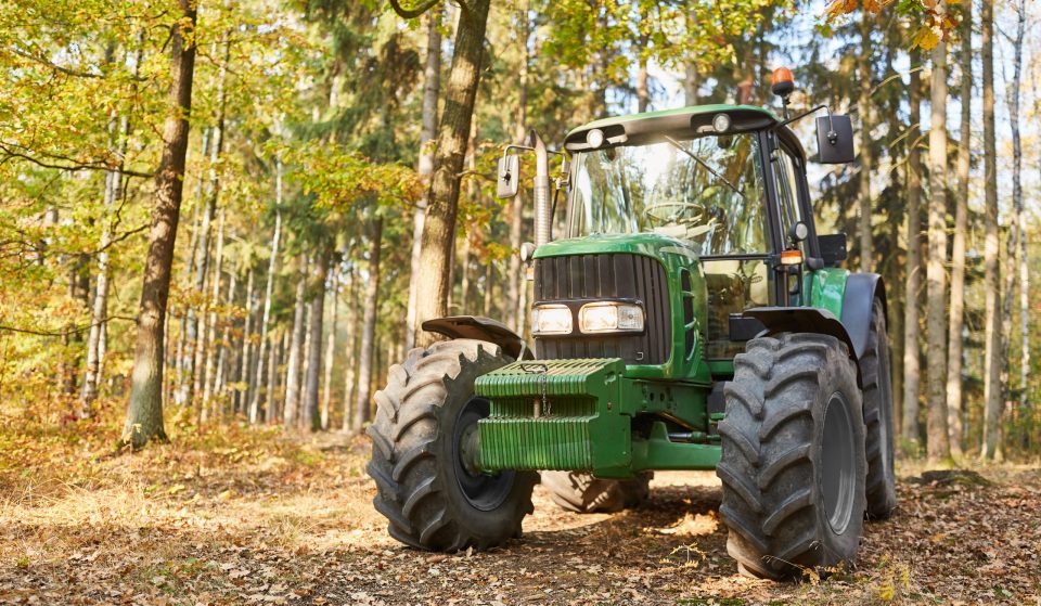 Green Tractor in an Autumn forest