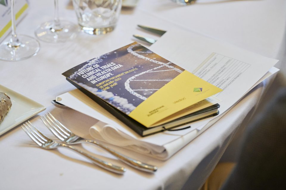 Table with plates and cutlery and a brochure of the event