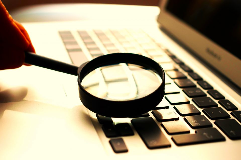 Conceptual picture of a magnifying glass over a computer